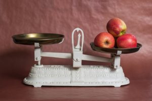 A scale with apples on the right side - cancer nutrition is about balance
