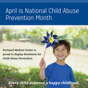 A young boy holding a blue pinwheel - April is National Child Abuse Awareness Month